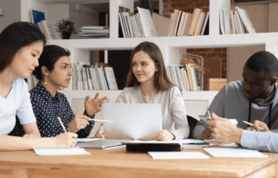 5 young people listen as one young woman shares her thoughts. This is a stock image and does not include those from the pilot project.